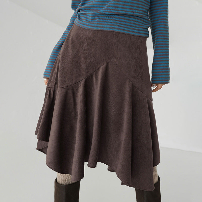 Brown skirt worn by a person on a plain background