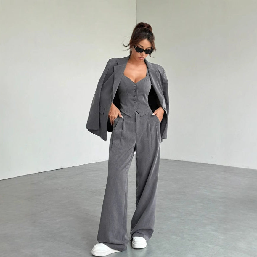Woman wearing a gray suit in a minimalistic setting